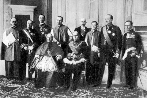 Cardinal Gasparri and Benito Mussolini (seated) after exchanging treaty ratifications in the Hall of Congregations, the Vatican, June 7th 1929