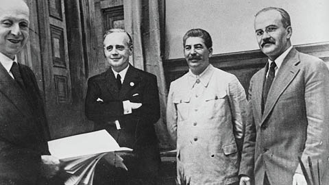 Soviet Commissar for Foreign Affairs Vyacheslav Mikhailovich Molotov, far right, General Secretary of the Communist Party Josef Stalin, second from right, and German Reich Foreign Minister Joachim von Ribbentrop, third from right, pose together after signing the German-Soviet non-aggression pact in Moscow, August 23, 1939, AP Photo