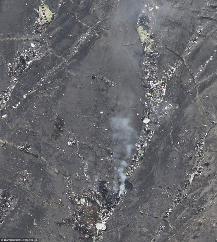 Parts of the plane, none larger than a small car, are pictured on the side of the mountain where the Airbus A320 crashed