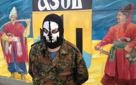 Phantom, 23, a fighter in the Azov battalion, outside its HQ in the Ukrainian seaside town of Urzuf